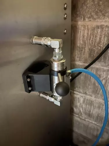 External chemical injector fitted onto the side of a Nilfisk Truck Booster for a farm installation in Ellistown. This modification improved detergent application and cleaning performance for regular agricultural washdown work.